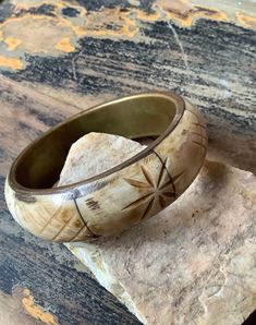 "Awesome vintage brass and bone bangle bracelet. This chunky boho bracelet features inlaid cream, tan and brown hues of carved design bone with brass frame. Great on its own or stacked with other bracelets   Measures: 2.5\" in diameter 3.0\" outside diameter 7/8\" width  In very good vintage condition. Please note: ALL the items in my shop are VINTAGE items and the majority are in VINTAGE pre-loved condition. I strive to describe each item as accurate as possible but please be sure to refer to p Texas Chainsaw, The Bangles, Hippie Bracelets, Carved Bone, Bone Horn, Boho Bracelet, Bracelet Boho, Bone Carving, Bracelet Vintage