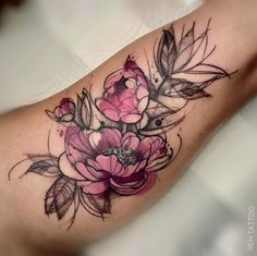 a woman's arm with flowers and leaves on it