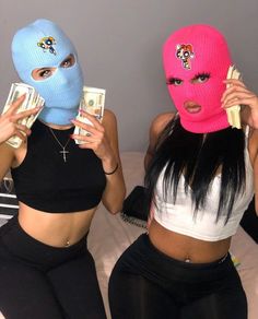 two women in matching masks holding cash