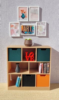 there is a shelf with many different items on it and pictures above the bookshelf