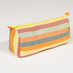 Handwoven in yellow diamond weave striped cotton in bright yellows, magenta, and orange, the convenient sized multipurpose cosmetics bag fits in your purse, tote bag, or suitcase. The waterproof lining protects everything else! Long handled zipper pull makes it easy to pull out what you need. 8”L x 3”W across the bottom x 4.5” D. Waterproof ripstop nylon lining in bright orange Long pull zipper Washable. Ethically made Magenta And Orange, Cotton Jewelry, Lime Yellow, Jewelry Roll, Diamond Weave, Cosmetics Bag, Toiletry Bags, Yellow Diamond, Crochet Crafts