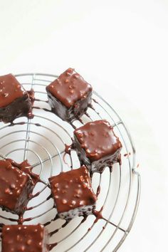 chocolate brownies are sitting on a wire rack with melted chocolate drizzled over them