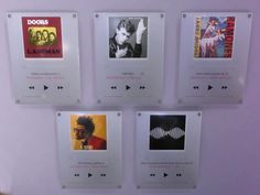 there are four pictures on the wall with sound waves in each one and an mp3 player below them