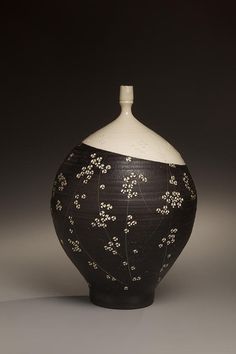 a black and white vase sitting on top of a table