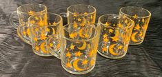 six glass mugs with yellow stars and moon designs