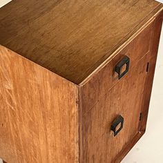 a wooden cabinet with two drawers on the front and one drawer open to show what's inside