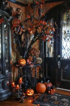 a halloween tree with pumpkins and other decorations