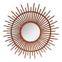 a mirror that is made out of sticks and has a circular design on the front