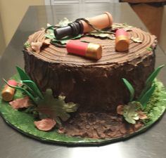 a cake made to look like a tree stump with lipstick and leaves around it on a table