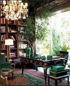 a living room filled with lots of furniture and a chandelier hanging from the ceiling