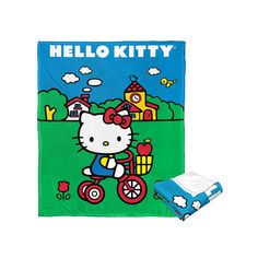 a hello kitty towel and blanket set on a white background with a blue bag next to it