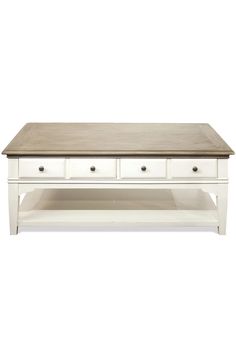 a white coffee table with drawers underneath it