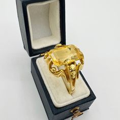 Antique Victorian 14k yellow gold ring with an emerald cut citrine gem. This is a beautiful unique piece that is a great state for its age. Jewelry box in the photos is not included. Precious Metals/Materials: 14k gold Weight: 5.38g Stones: Emerald Cut Citrine  Size:  8 US, 57 EU Era:  Victorian based on style and design Markings: None Yellow Emerald-cut Topaz Ring, 14k Gold Faceted Birthstone Ring, Yellow Citrine Topaz Ring Rectangular Shape, Victorian Gold Signet Ring With Gemstone, Fine Jewelry Yellow Gold Octagon Topaz Ring, Yellow Gold Octagon Topaz Ring Fine Jewelry, Gold Faceted Emerald Ring Gift, Antique Gold Citrine Jewelry, Gold Faceted Emerald Ring As Gift