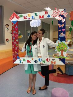 a man and woman standing in front of a sign