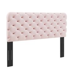 a pink headboard with black legs and buttons