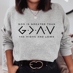 Wear your faith and stay warm all winter while wearing this God Is Greater sweatshirt. This cool Christian sweatshirt is soft, comfy, and strong on faith. Pair it with leggings for a comfortable style or your favorite jeans for a casual faith fashion. Dress it up with one of our Christian necklaces or bracelets. However you like to wear it, it's sure to be a staple in your God sweatshirt collection! God is greater than anything we may face in a day - greater than the highs and lows and everythin Christian Necklaces, Christian Hats, Sweatshirt Collection, Faith Clothing, Christian Necklace, Patriotic Outfit, Christian Sweatshirt, Comfortable Style, Christian Clothing