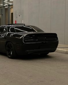 a black car parked in front of a building