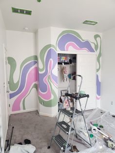 a room that has some paint on the walls and is being painted with different colors