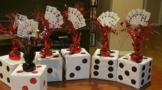 four white dices with red and black polka dots on them sitting on a table