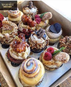 a box filled with lots of different types of cupcakes