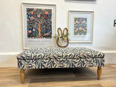 a blue and white bench sitting in front of two framed pictures on the wall next to each other