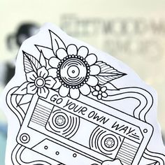 a sticker that says go your own way with a cassette and flowers on it