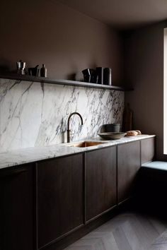 a kitchen with marble counter tops and wooden cabinets