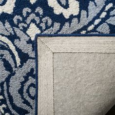 an upholstered area rug with blue and white designs on it's sides