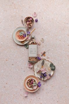 the table is covered with flowers and dishes