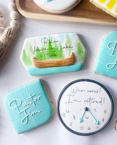 decorated cookies with writing on them next to a clock