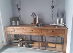 a wooden cabinet with two cages on top of it