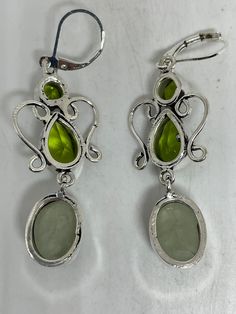 Delicate and detailed hand set Antique and Silver lever back earrings Genuine green peridot and Jade These dangle earrings are over an inch long Can be converted to clip ons. All jewelry is shipped free in the US in a nice gift box. Check out our over a THOUSAND great reviews Elegant Lime Green Dangle Earrings, Green Peridot Drop Earrings, Elegant Green Nickel-free Clip-on Earrings, Green Oval Clip-on Earrings, Oval Green Clip-on Earrings, Green Peridot Teardrop Earrings, Green Peridot Dangle Earrings, Silver Dangle Peridot Earrings, Silver Peridot Dangle Earrings