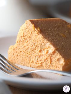 a piece of cake sitting on top of a white plate next to a silver fork