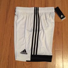 Adidas Boys Youth Large Shorts. Color White & Black. 100% Polyester. 17 Inches Long With Drawstrings. New With Tags. White Three Stripes Athletic Shorts For Sports, White Three Stripes Athletic Shorts, Adidas Sporty White Athletic Shorts, White Three-stripe Sports Shorts, White Adidas Sports Shorts, White Shorts With Three Stripes, White Cotton Shorts With Three Stripes, White Three Stripes Shorts, Adidas White Sports Shorts