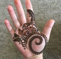 a person's hand with henna tattoos on it