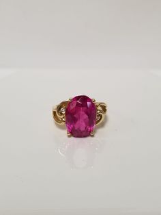 "Thanks for shopping our vintage estate store. We tend to sell well below wholesale and truly hope you enjoy all of our items. Many of the items are one of a kind, so please enjoy scrolling through the pictures and hopefully something will catch your eye. Spots are from reflections or camera. Estate 14k yellow gold created 6ct oval red ruby CZ .03ct Diamond cocktail filigree ring. No scratches on the gem. Stunning. Vintage setting, one that someone will love. Gem is testing natural, but it's created ruby. Size: 6 Setting: 1/2\" Band width: 2mm Weight:  4.89 grams Marked 14k. Gem is stunning." Formal Oval Ruby Ring With Center Stone, Pink Oval Ring For Formal Occasions, Collectible Yellow Gold Oval Rings, Classic Pink Ruby Ring For Formal Occasions, Classic Pink Ruby Ring For Anniversary, Formal Ruby Birthstone Ring Stamped 14k, Formal Ruby Ring With Oval Cabochon And Accent Stones, Formal Oval Cabochon Ruby Ring With Accent Stones, Oval Ruby Ring Stamped 14k