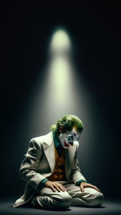 a man dressed as the joker sitting in front of a light