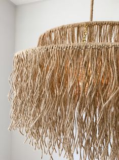 a chandelier hanging from a ceiling in a room with white walls and flooring