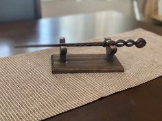 a metal object sitting on top of a wooden table