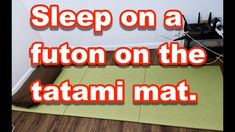 a room with a green mat on the floor and text that reads sleep on a futon on the tatami mat