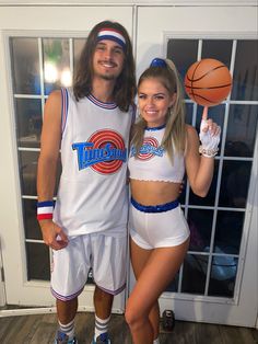 a man and woman dressed up as basketball players