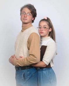 a man and woman standing next to each other with their arms around each other's shoulders