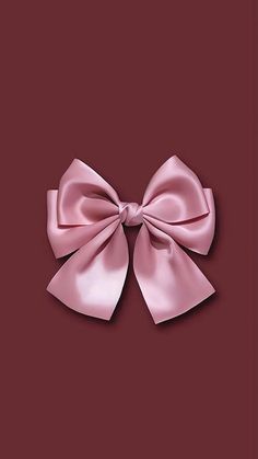 a pink bow on a red background