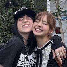 two young women are posing for the camera with their arms around each other and smiling