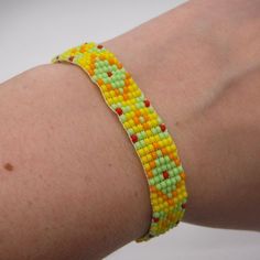 Bracelet Is Hand Beaded Using A Loom. Made With Yellow, Lime Green, Orange, And Red Czech Glass Beads. Silver Tone Ribbon Crimp Ends With A Lobster Clasp Closer. Light Weight, Great For All Day Wear. Add A Pop Of Color To Your Outfit! To Keep Your Bracelet In Great Shape, Avoid Water. And Dry Immediately If Contact Occurs. 6 - 7.5 Inches Long 1/2 Inches Wide Adjustable Yellow Bracelet For Friendship, Adjustable Yellow Bracelets For Friendship, Tiny Yellow Beads For Summer, Casual Yellow Beads For Beach, Adjustable Yellow Beaded Bracelets With Tiny Beads, Handmade Yellow Friendship Bracelets, Adjustable Yellow Beaded Bracelets, Bohemian Yellow Friendship Bracelets As Gift, Handmade Yellow Beads For Summer