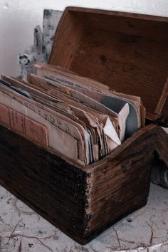 an old wooden box filled with lots of papers