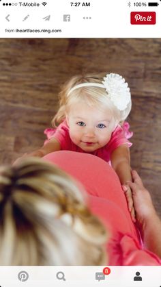 a woman holding a baby in her arms