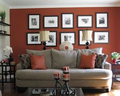 a living room filled with lots of furniture and pictures on the wall above it's coffee table