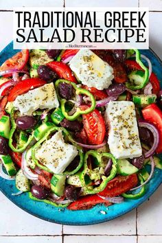 traditional greek salad recipe with feta cheese, tomatoes and cucumbers in a blue bowl