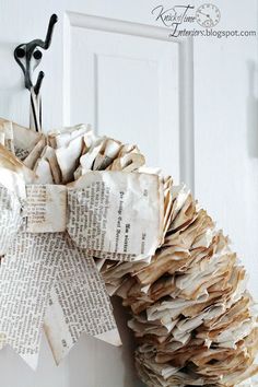 an old book page wreath hanging on the front door